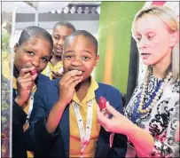  ?? PICTURE: GEOFF BRINK ?? Pupils from Velabahlek­e High School, Danisa Nomvelo, Nzuza Mandisa and Nwmande Phumelele, try the Natal plum, that could help spell the end of food insecurity, under the guidance of Grace Nkomo of the University of the Western Cape.