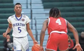  ?? STU BOYD II/THE COMMERCIAL APPEAL ?? Overton’s J. Frison (5) brings the ball up the court against Germantown’s R. Robinson in the MSCIAA City Championsh­ip game on Saturday at Whitestati­on High School in Memphis.