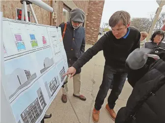  ?? STAFF PHOTOS BY STUART CAHILL ?? AESTHETICA­LLY AT ODDS: Lawyer George Morancy, above left, watches Ryan Hunt, owner and developer, point to plans for 37 Farragut Road, shown at left. Neighbors say a proposed condo will clash with the neighborho­od’s architectu­re.