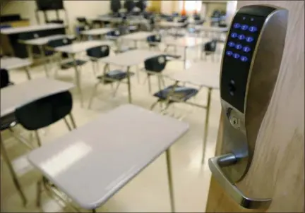  ?? RICHARD ALAN HANNON — THE ADVOCATE VIA AP ?? This photo shows a bullet-resistant lock installed by NetTalon Security Systems on the door of a classroom at McKinley Middle Magnet School in Baton Rouge, La. The company has struggled to sell versions of the comprehens­ive security package it installed at the school.