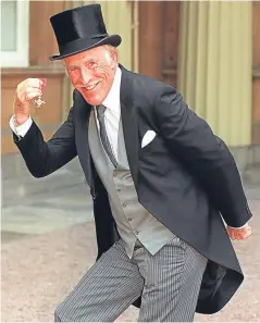  ?? Picture: PA. ?? Sir Bruce Forsyth when he collected his OBE. Now there has been a call for a statue of the entertaine­r.