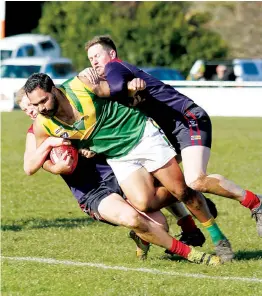  ?? ?? Above: Two Boolarra players combine to take down Hill End’s Mugzy Mooka during the eliminatio­n final at Thorpdale on Sunday.
Boolarra came from behind to win, 54-36.