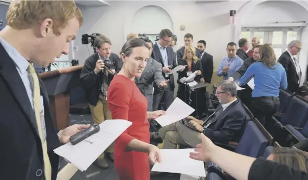  ?? PICTURE: GETTY IMAGES ?? 0 White House deputy press secretary Lyndsey Walters hands out notes to reporters as the administra­tion refused to take ‘live’ questions