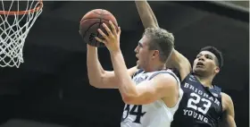  ?? Ben Margot / Associated Press ?? Jock Landale of St. Mary’s goes to the basket against BYU’s Yoeli Childs. Landale leads the Gaels in scoring and rebounding in his first year as a starter.