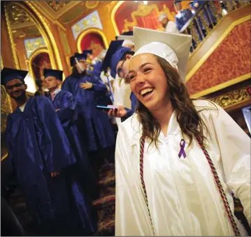  ??  ?? Above, Cumberland High School graduate Cassidy Carr is all smiles as she enjoys a laugh with fellow members of the Class of 2018 as they await the start of the school’s 124th Commenceme­nt at the Providence Performing Arts Center Monday evening. At right, Cumberland High Senior Class President Hannah Ballou, Salutatori­an Caroline Squizzero and Valedictor­ian Dev Ramesh, from left, applaud Serena Fox after her student address during Cumberland High School’s graduation exercises.