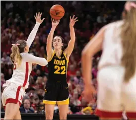  ?? AP PHOTO/REBECCA S. GRATZ ?? Iowa’s Caitlin Clark, second from left, shoots against Nebraska’s Kendall Moriarty, left, during the second half of an NCAA college basketball game Sunday, Feb. 11, 2024, in Lincoln, Neb.