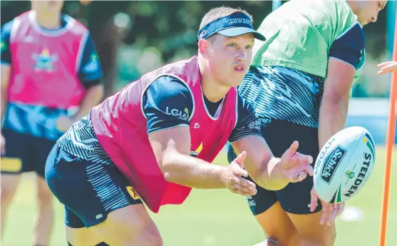  ?? LONG ROAD BACK: Cowboys squad member Reuben Cotter goes through team drills during pre- season training at the Townsville Sports Reserve. ??