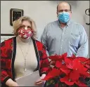  ?? Submitted photo ?? DONATION: Jackson House Executive Director Janie Smith, left, receives a donation from County Judge Daryl Mahoney to help buy food for community members.