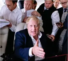  ?? ?? In full flight: Boris Johnson answering journalist­s’ questions on an aeroplane to Madrid yesterday