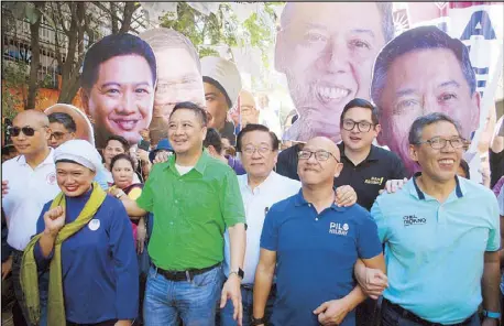  ?? BOY SANTOS ?? Otso Diretso senatorial candidates (from left) Rep. Gary Alejano, civic leader Samira Gutoc-Tomawis, former congressma­n Erin Tañada, election lawyer Romulo Macalintal, former solicitor general Florin Hilbay, Sen. Paolo Benigno ‘Bam’ Aquino IV and rights lawyer Jose Manuel ‘Chel’ Diokno campaign in the streets of Caloocan City yesterday.
