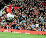  ?? GETTY IMAGES ?? Manchester United’s Marcus Rashford scores his side’s opening goal during the English Premier League match against Liverpool at Old Trafford in Manchester yesterday.