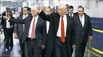  ?? Evan Vucci/Associated Press ?? President-elect Donald Trump and Vice President-elect Mike Pence wave as they visit the Carrier factory Thursday in Indianapol­is. Mr. Trump is threatenin­g to impose heavy taxes on U.S. companies that move jobs overseas and still try to sell their...