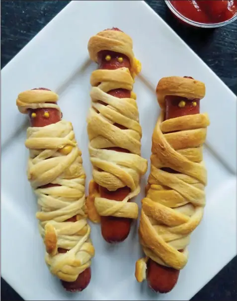  ??  ?? Little ghouls and goblins will love these crescent-roll-wrapped Mummy Hot Dogs.