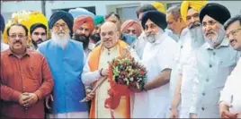  ?? RAVI KUMAR/HT ?? BJP president Amit Shah (C) flanked by excm Parkash Singh Badal and SAD president Sukhbir Badal, besides state BJP chief Shwait Malik and others, as he arrives for a meeting; and (right) Shah, with local MP Kirron Kher, meets ‘Flying Sikh’ Milkha...