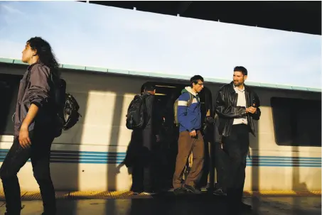  ?? Scott Strazzante / The Chronicle ?? Commuters exit a BART train at the West Oakland Station. BART riders have grown increasing­ly dissatisfi­ed with service.