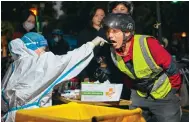  ?? Photo: AFP ?? A man gives a swab sample in Shanghai’s Jing’an district.
