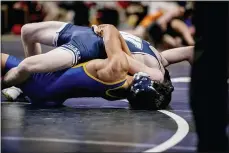  ?? NATE HECKENBERG­ER - FOR MEDIANEWS GROUP ?? Downingtow­n East’s Keanu Manuel scores the winning near-fall points against West Scranton’s Austin Fashouer in a win in the 120-pound consolatio­ns.