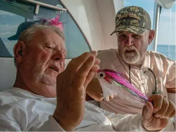  ??  ?? Jake Jordan (left) and North Carolina guide Brian Horsley discuss the merits of fly patterns.