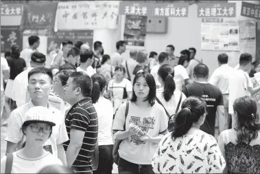  ?? ZHANG ZHAOJIU / FOR CHINA DAILY ?? High school graduates and their parents attend a fair on career guidance and college majors held on June 26 at Huaiyin Normal University in Huai’an, Jiangsu province. Faculties from many universiti­es aid students to choose their majors.