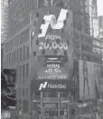  ?? NASDAQ ?? This sign in New York City shows the Dow as it hit 20,000 for the first time.