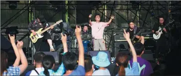  ?? CAI XIANGXIN / XINHUA ?? Top left: Liu Huan is one of China’s best-known pop stars and songwriter­s. PROVIDED TO CHINA DAILY Top right and above right: Qiu De (top) and Qin Fanqi, winners of an annual music competitio­n launched by the Liu Huan Original Music Foundation, perform after their respective victories this year and last year. PHOTOS PROVIDED TO CHINA DAILY Above: Fans attend the Strawberry Music Festival in Fuxin, Liaoning province, on July 17.