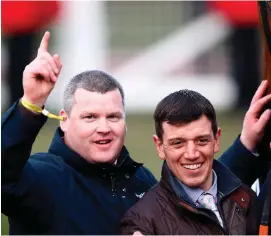  ??  ?? Gordon Elliott celebrates with assistant trainer Davy Condon after The Storytelle­r’s victory at Cheltenham yesterday