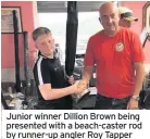  ??  ?? Junior winner Dillion Brown being presented with a beach-caster rod by runner-up angler Roy Tapper