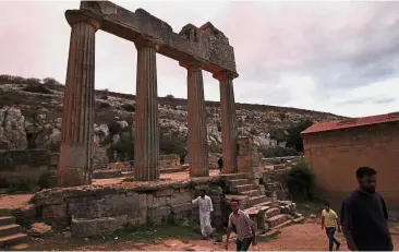  ?? — AFP ?? Ancient history: People visiting ruins at the archaeolog­ical site of the ancient Greek city of Cyrene and a principal city in the Hellenic world founded in 630 BC, located in the suburbs of the Libyan eastern town of Shahat, east of Benghazi.