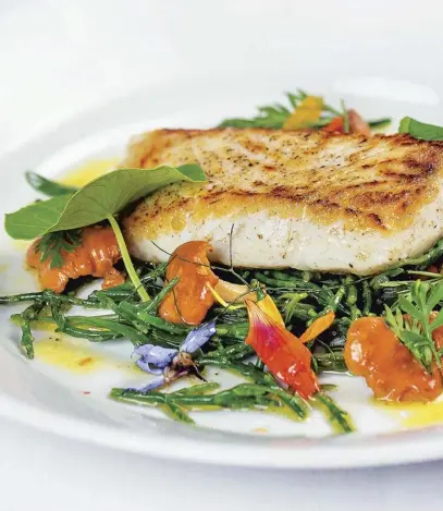  ??  ?? Fillet of halibut with samphire and chanterell­es, main; cherry and frangipane tart, right