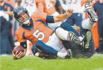  ?? AAron Ontiveroz, The Denver Post ?? Broncos quarterbac­k Joe Flacco is tackled by Nick Williams of the Chicago Bears after attempting to run Sunday.