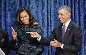  ?? OLIVIER DOULIERY / ABACA PRESS / TNS ?? Former President Barack Obama and first lady Michelle Obama attend the unveiling of their official portraits at the National Portrait Gallery on Feb. 12 in Washington, D.C. The storytelli­ng couple look forward to producing a variety of series and...