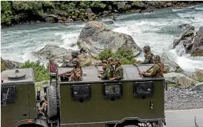  ?? GETTY IMAGES ?? An Indian army convoy heads towards a base in Ladakh as India and China beef up their military forces in the area.