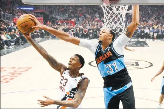  ??  ?? Los Angeles Clippers guard Lou Williams (left), has his shot blocked by Cleveland Cavaliers forward John Henson during the first half of an NBA basketball game on Jan 14 in Los Angeles. (AP)