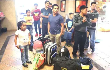  ??  ?? People arrive at an Annunciati­on House facility to be cared for after they were reunited with their children in El Paso, Texas. The parents were reunited at an I.C.E processing centre after being separated when they tried to cross into the United States. — AFP photo