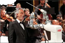  ??  ?? WHAT’S singer Andrea Bocelli thinking as he performs with the Lucca Philarmoni­c Orchestra… conducted by YuMi, a robot that has been taught to mimic all the movements of the orchestra’s actual conductor? Every week we give you the chance to write an...