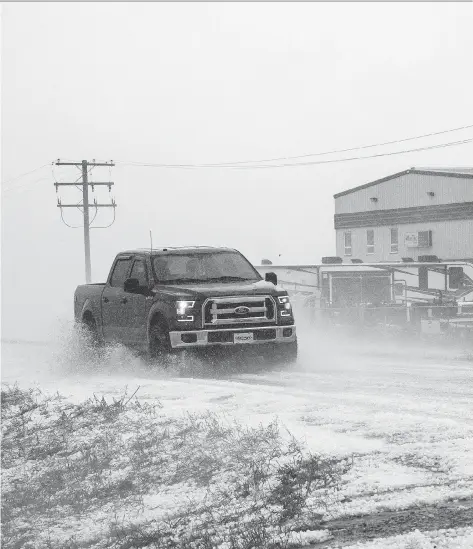  ?? COURTESY BYRON FICHTER FOTOGRAPHY ?? A truck braves the storm near Estevan that brought hail, rain and high winds to much of southeast Saskatchew­an on Thursday, causing damage to vehicle and homes, destroying plants, sparking flash flooding and causing extensive power outages.