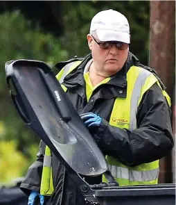  ??  ?? We’re watching you: Dustmen in Heanor, Derbyshire, check residentia­l bins for evidence of ‘contaminat­ed’ material