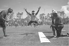  ?? JON AUSTRIA/NAPLES DAILY NEWS ?? Zyaire Morris, 14, from Stroudebur­g, Pennsylvan­ia, participat­es in the broad jump during the FBU (Football University) Top Gun Showcase youth combine in North Naples, Florida, on July 10.