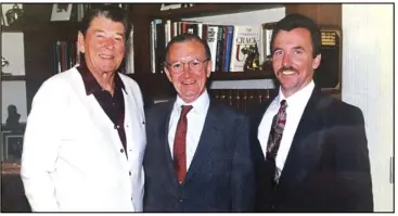  ?? ASSOCIATED PRESS ?? A family photo shows William Clotworthy (center) with his son Donald (right) and former President Ronald Reagan in Los Angeles in 1994. Clotworthy, who as the in-house censor for “Saturday Night Live” decided whether Eddie Murphy could say “bastard,” whether Joe Piscopo could make fart jokes and whether inebriated Romans could vomit on network television, died on Aug. 19 at a hospice facility in Salt Lake City. He was 95.