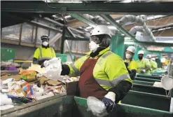  ?? Lea Suzuki / The Chronicle ?? At Recology’s initial sort deck, Tim Coleman separates out pieces of environmen­t-unfriendly flimsy and film plastic destined for landfill.