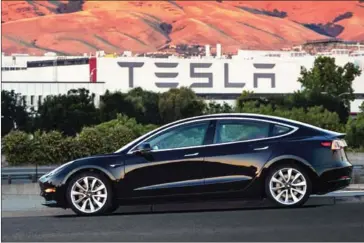  ?? TESLA ?? Tesla’s Model 3 has been preordered by 450,000 people. Will 2018 be the year Tesla’s able to deliver them in mass?
