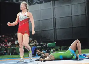  ?? MANISH SWARUP THE CANADIAN PRESS FILE PHOTO ?? Canada’s Erica Wiebe, left, celebrates after beating Nigeria’s Blessing Onyebuchi to take gold in women’s freestyle 76-kilogram wrestling at the Commonweal­th Games in 2018.