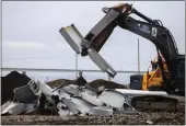  ?? JULIA NIKHINSON — THE ASSOCIATED PRESS ?? A shearer breaks apart salvaged pieces of the collapsed Francis Scott Key Bridge at Tradepoint Atlantic, Friday, April 12 in Sparrows Point, Md.