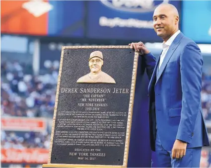  ?? KATHY WILLENS/ASSOCIATED PRESS ?? Retired New York Yankees shortstop Derek Jeter poses with a replica of the plaque that will be installed in Monument Park. Jeter personally picked Mother’s Day for his tribute.