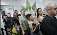  ?? JOHN LOCHER — THE ASSOCIATED PRESS ?? People wait in line at the Essence cannabis dispensary, Saturday in Las Vegas. Nevada dispensari­es were legally allowed to sell recreation­al marijuana starting at 12:01 a.m. Saturday.