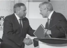  ?? FRANK GUNN/AFP/GETTY IMAGES ?? Thomas Mulcair, left, didn’t give non-NDP voters reasons to be spooked by the prospect of the first New Democrat federal government.