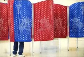  ?? David Goldman/Associated Press ?? A voter in Manchester, N.H., casts a ballot in a New Hampshire primary. The primary for the Democratic presidenti­al candidates will be held on Feb. 11, 2020, in New Hampshire.