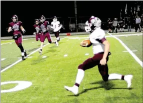  ?? Photo by Mark Humphrey ?? Gentry senior quarterbac­k Jon Faulkenber­ry got loose for this long touchdown run at Lincoln. The Pioneers earned a playoff berth by beating the Wolves, 34-14, Friday.