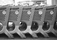  ??  ?? Target shopping carts sit inside a company store in Chicago on May 16, 2016. — WPBloomber­g photo