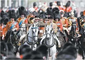  ?? FRANK AUGSTEIN/AP ?? Queen Elizabeth II, 93, rides in a carriage Saturday to attend the annual Trooping the Colour parade in London. She marked her official birthday; her actual birthday is April 21.